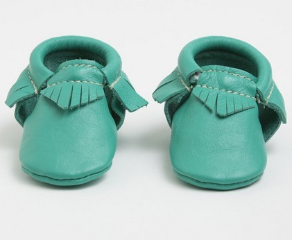 Close-up of a soft leather baby moccasin in brown color