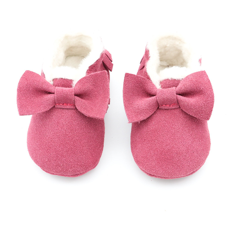 Close-up of a soft leather baby moccasin in brown color